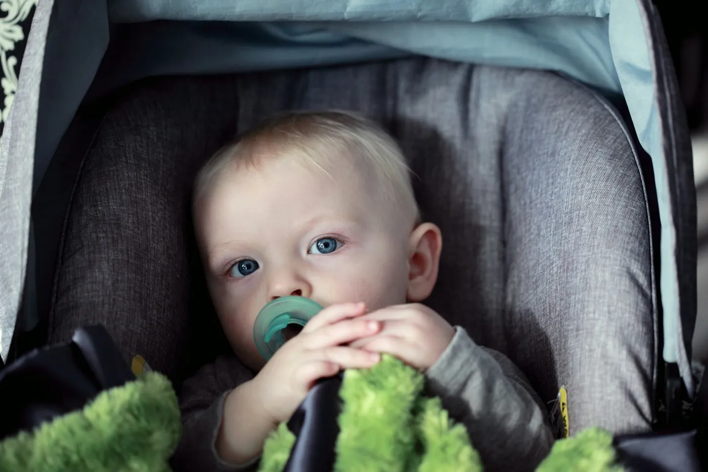A baby buckled into a car seat