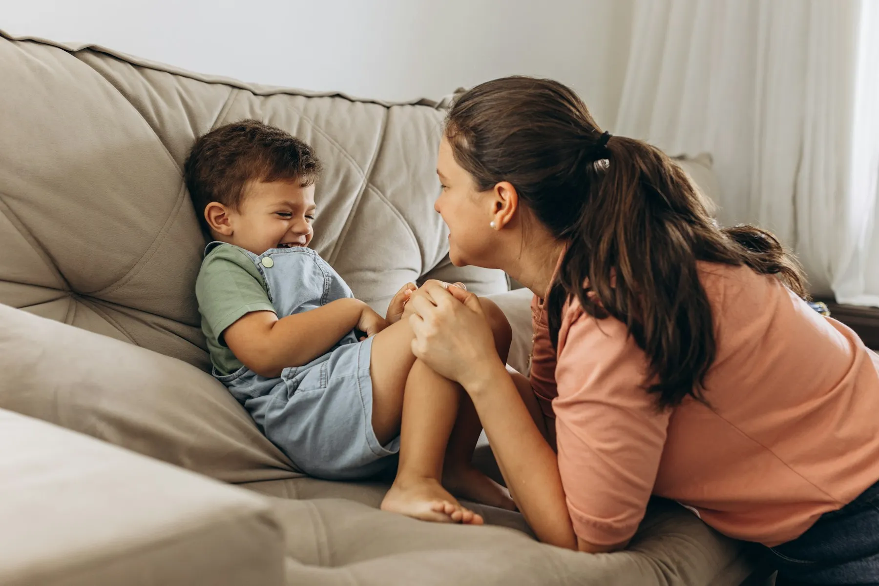 A toddler talking with a parent